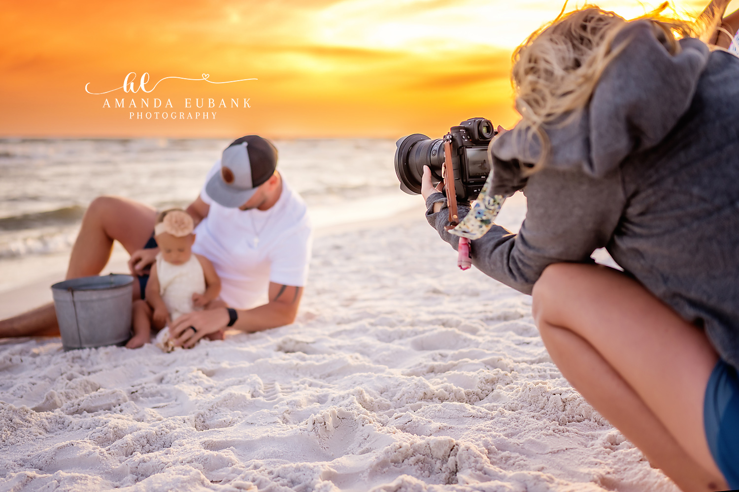 Destin family photographer behind the scenes capturing dad and baby on beach at sunset