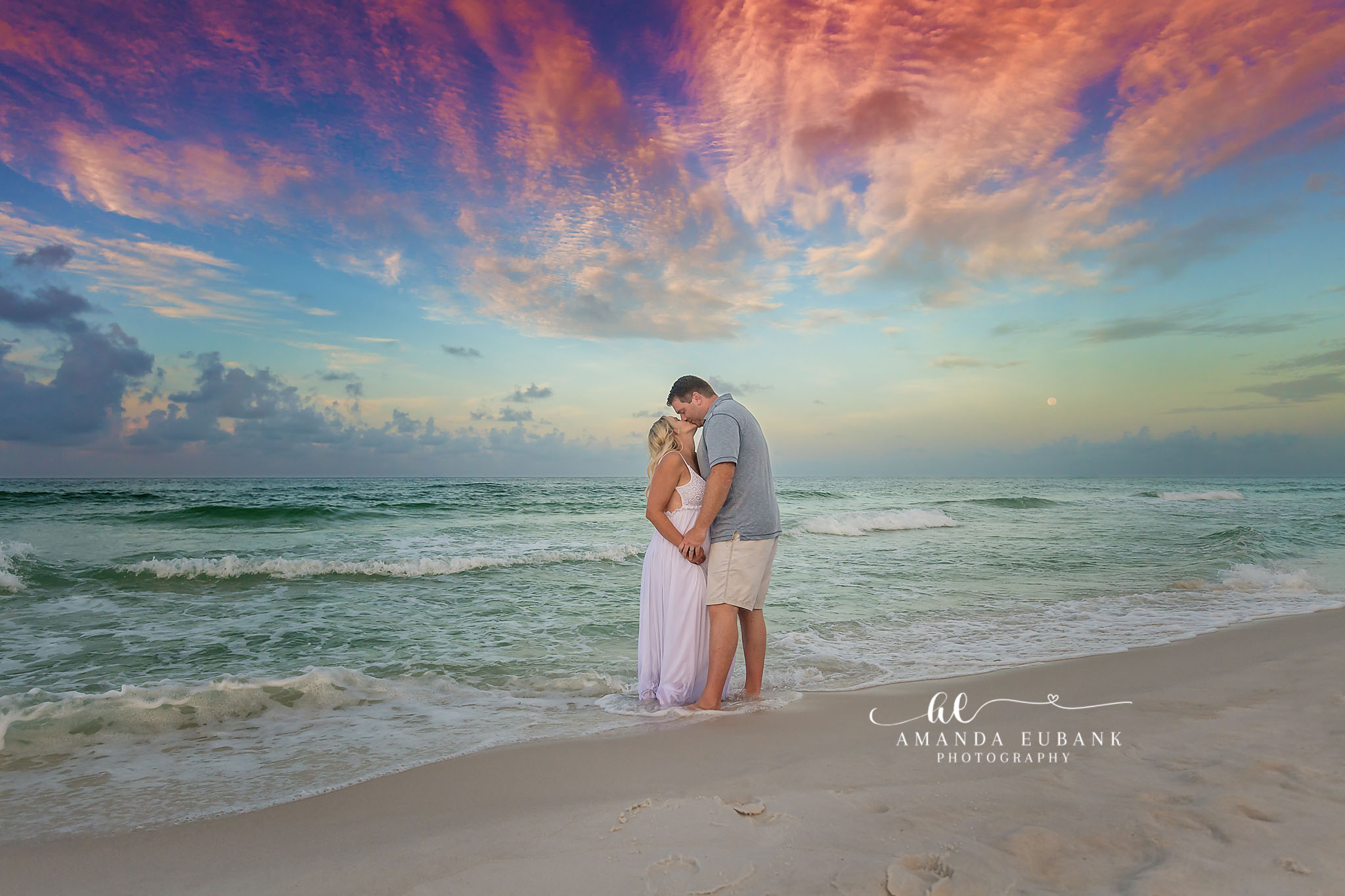 Destin engagement photographer captures couple embracing at sunset on the beach